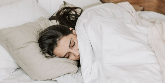 Schlafende Frau in weissen Bettlaken