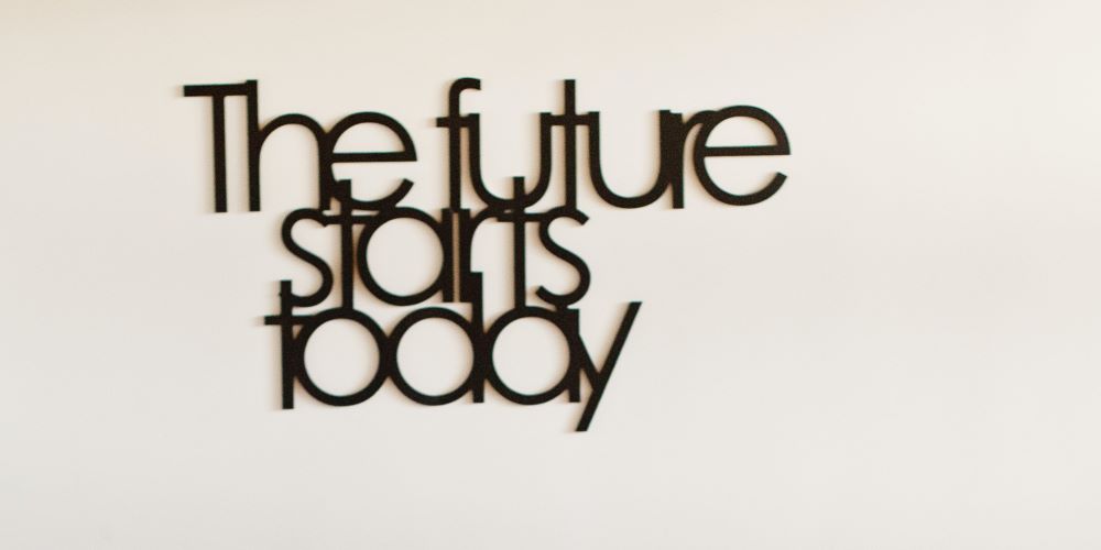 Schwarzer Schriftzug an weisser Wand "The future starts today".
